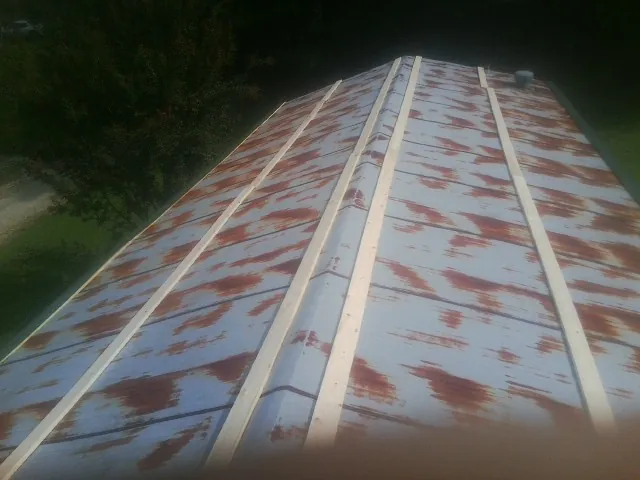 Rusted metal roof panels with new wood purlins before replacement — Storm Damage Roof Repair in Nixa by Roofing Brothers
